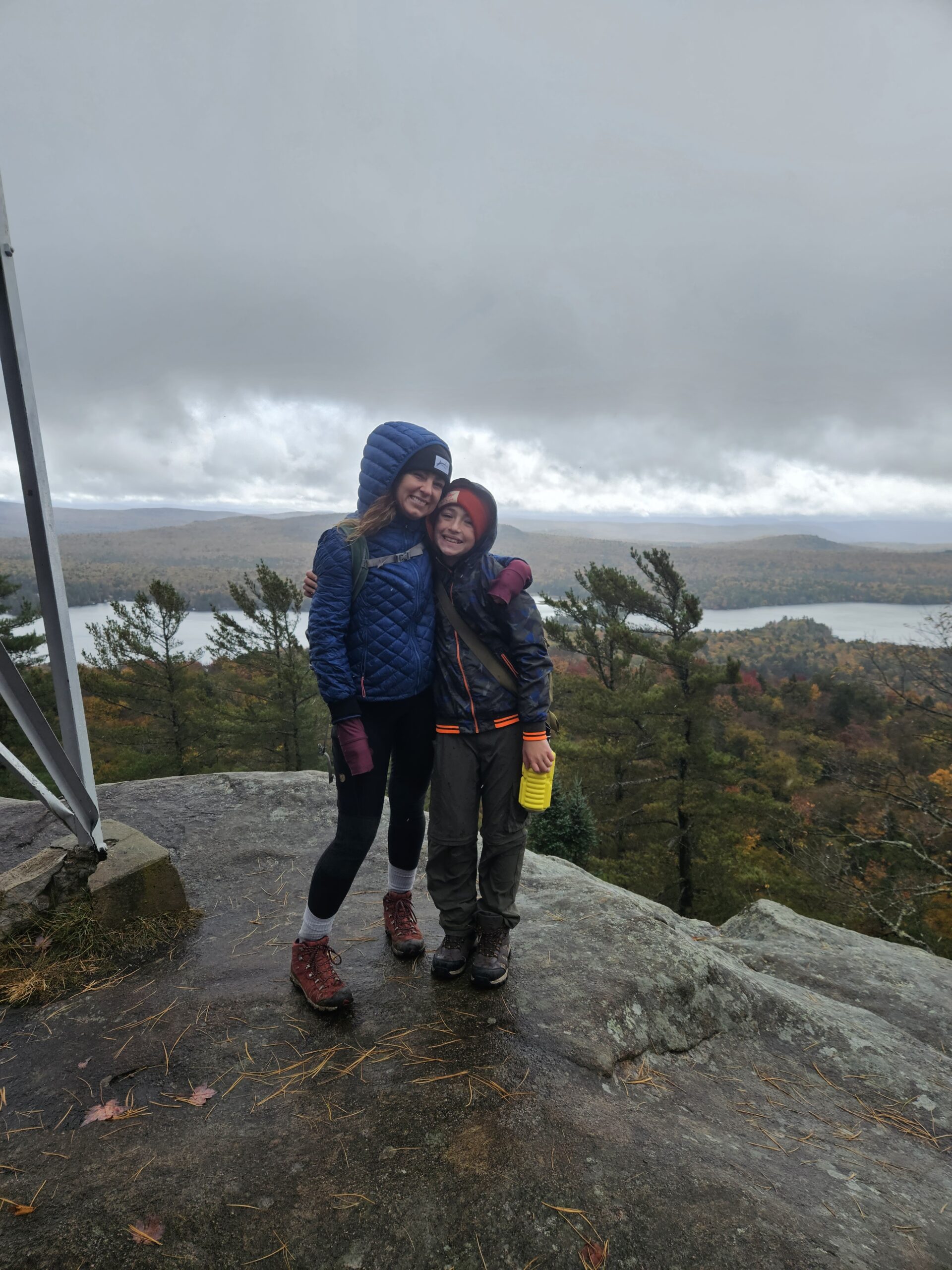 Stephanie and Max at a fire tower on a fall hike in the Adirondacks